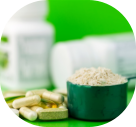 food supplement pills and protein powder in plastic spoon on green background