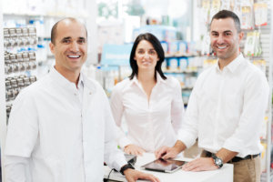 portrait of three smiling pharmacist